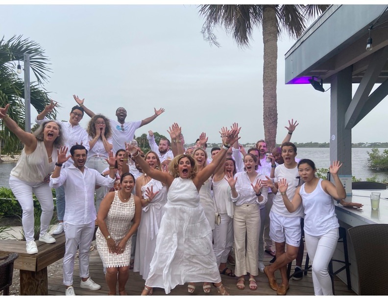 The team celebrating together at an outdoor waterfront team-building event